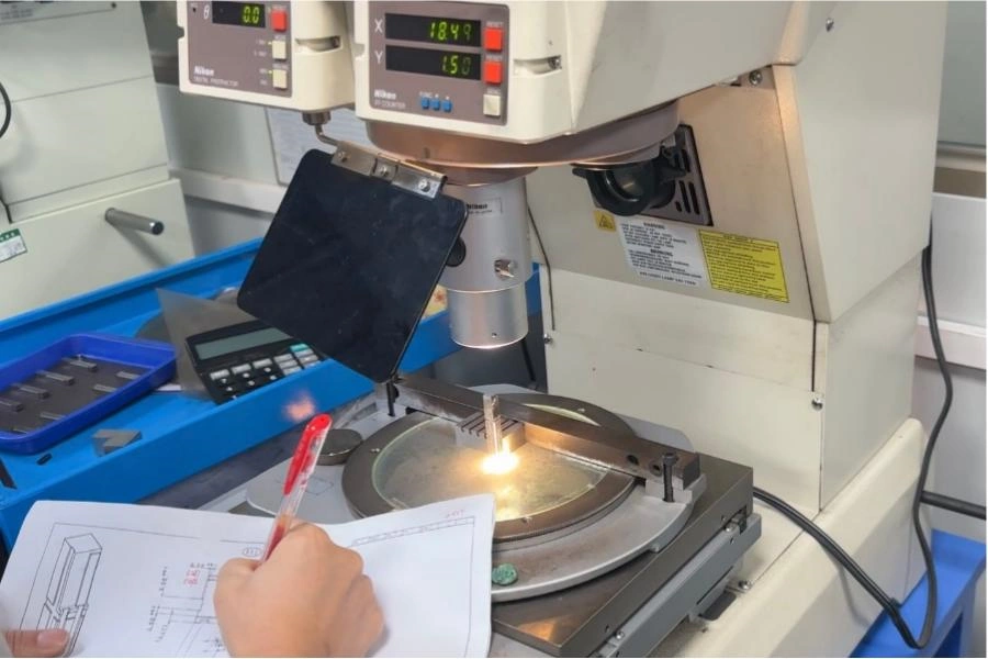 Dimensional inspection of a precision part using a profile projector and technical drawing
